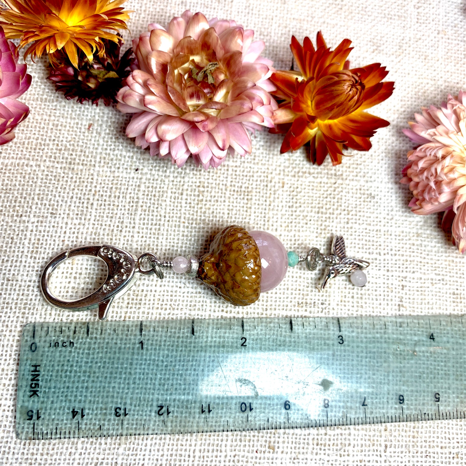 a ruler with flowers and a stone on it